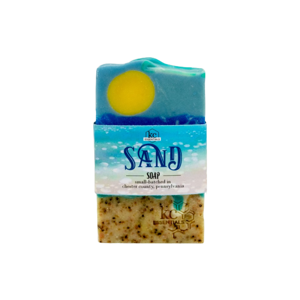 Artisan Bar Soap that shows a beach with sand surf and yellow sun high in the blue sky with wisps of clouds