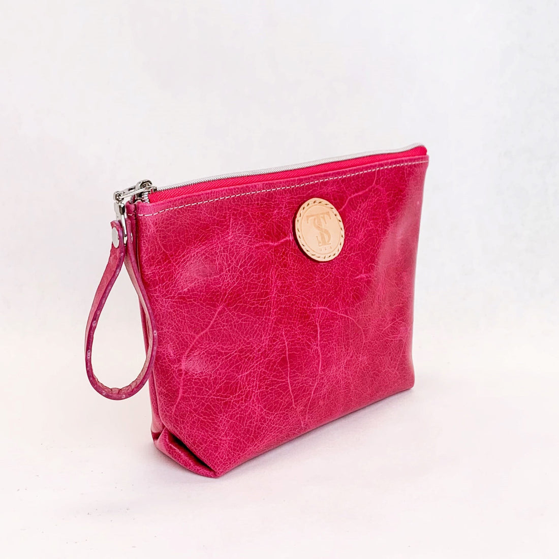 Side view T5 Cosmetics case toiletry bag designer handcrafted in smooth calf leather in hot Barbie pink.