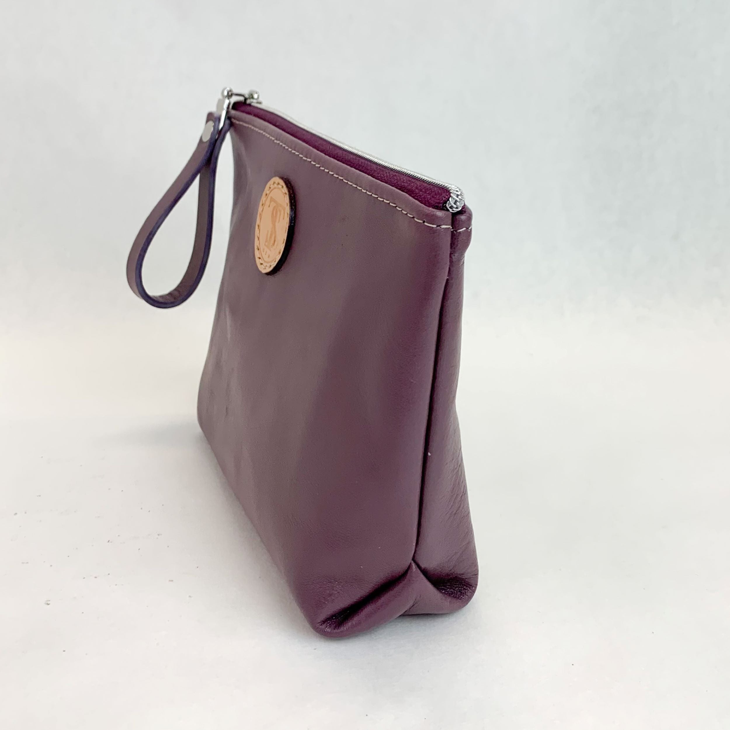 Side view T5 Cosmetics case toiletry bag designer handcrafted in smooth calf leather in lavender purple.