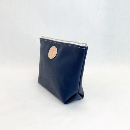 Side view T5 Cosmetics case toiletry bag designer handcrafted in smooth calf leather in nautical navy blue.